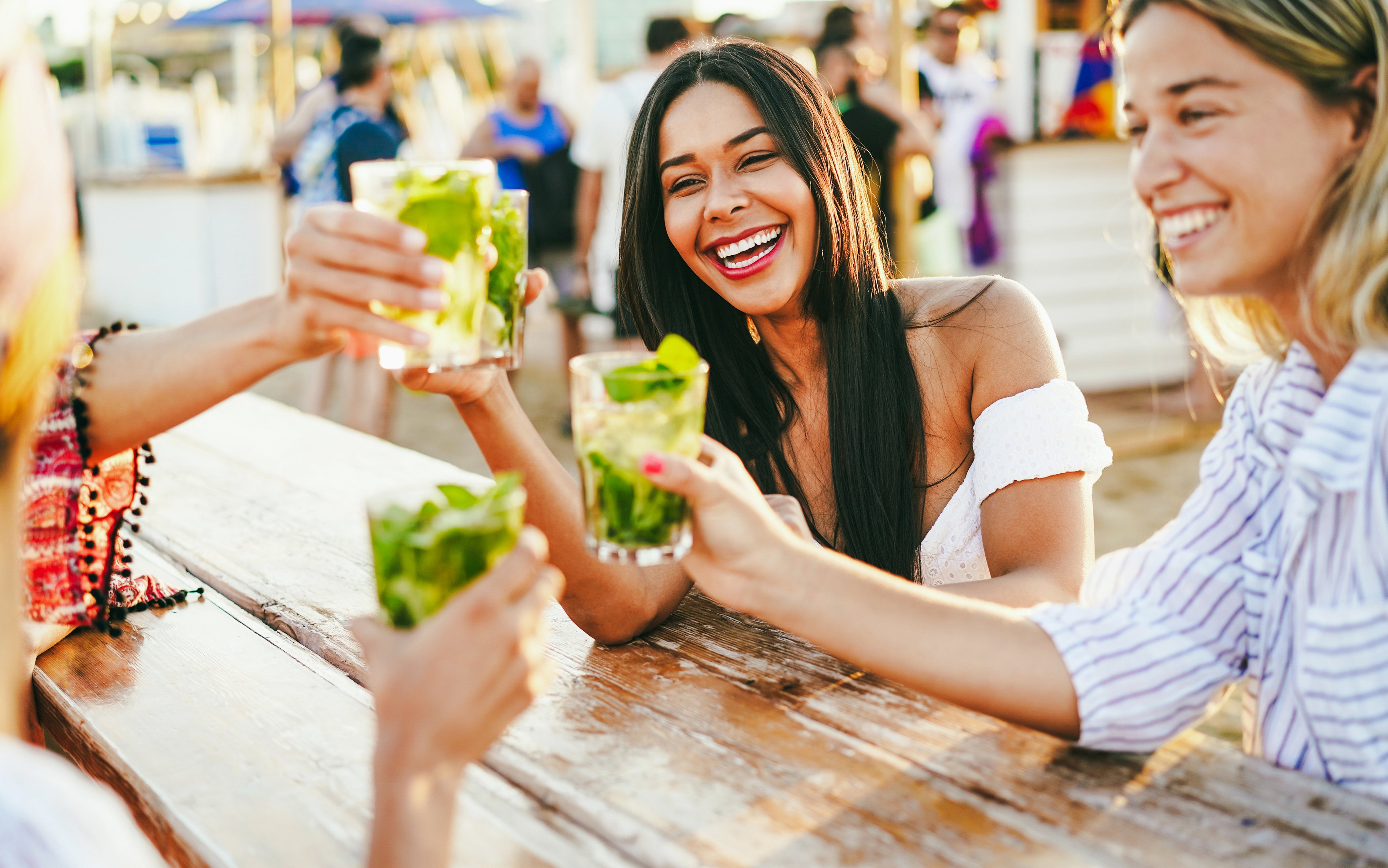 Friends enjoying drinks at a beach bar.