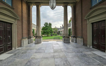 Courtyard view through columns at historic site in Haarlem, part of self-guided city exploration game.