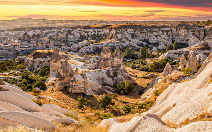 Cappadocia rock formations at sunset during guided day tour with hotel transfers.