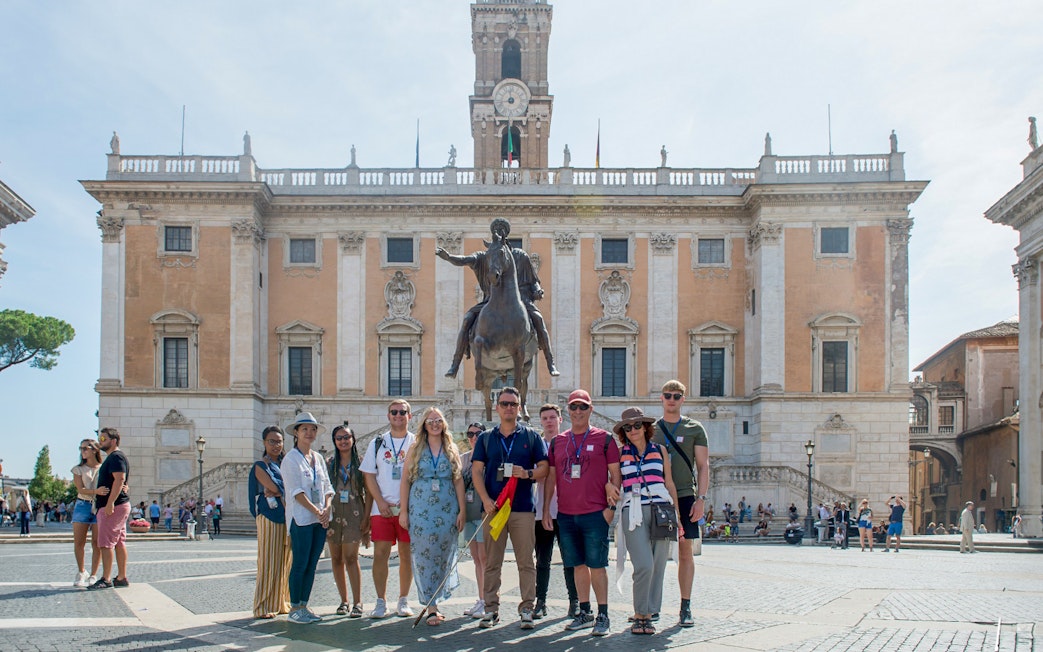 Group in front of Capitoline Museums with equestrian statue, Rome tour.