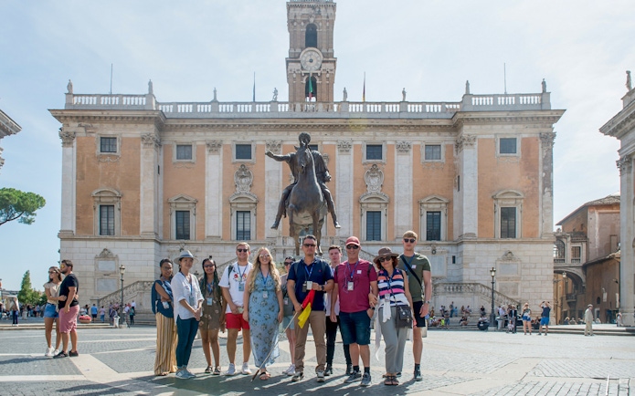 Group in front of Capitoline Museums with equestrian statue, Rome tour.