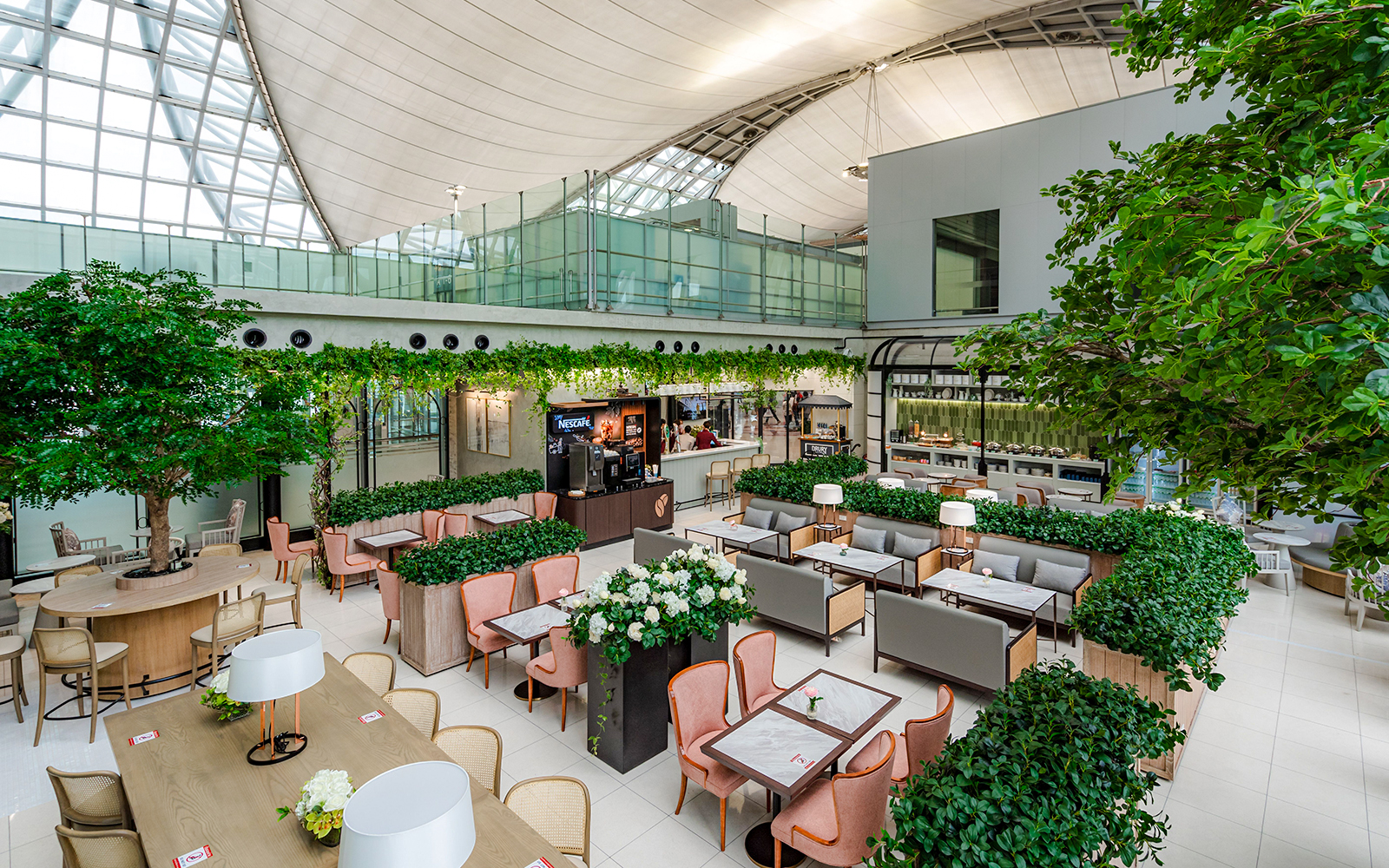 Coral Executive Lounge seating area with greenery, Bangkok airport, Thailand.
