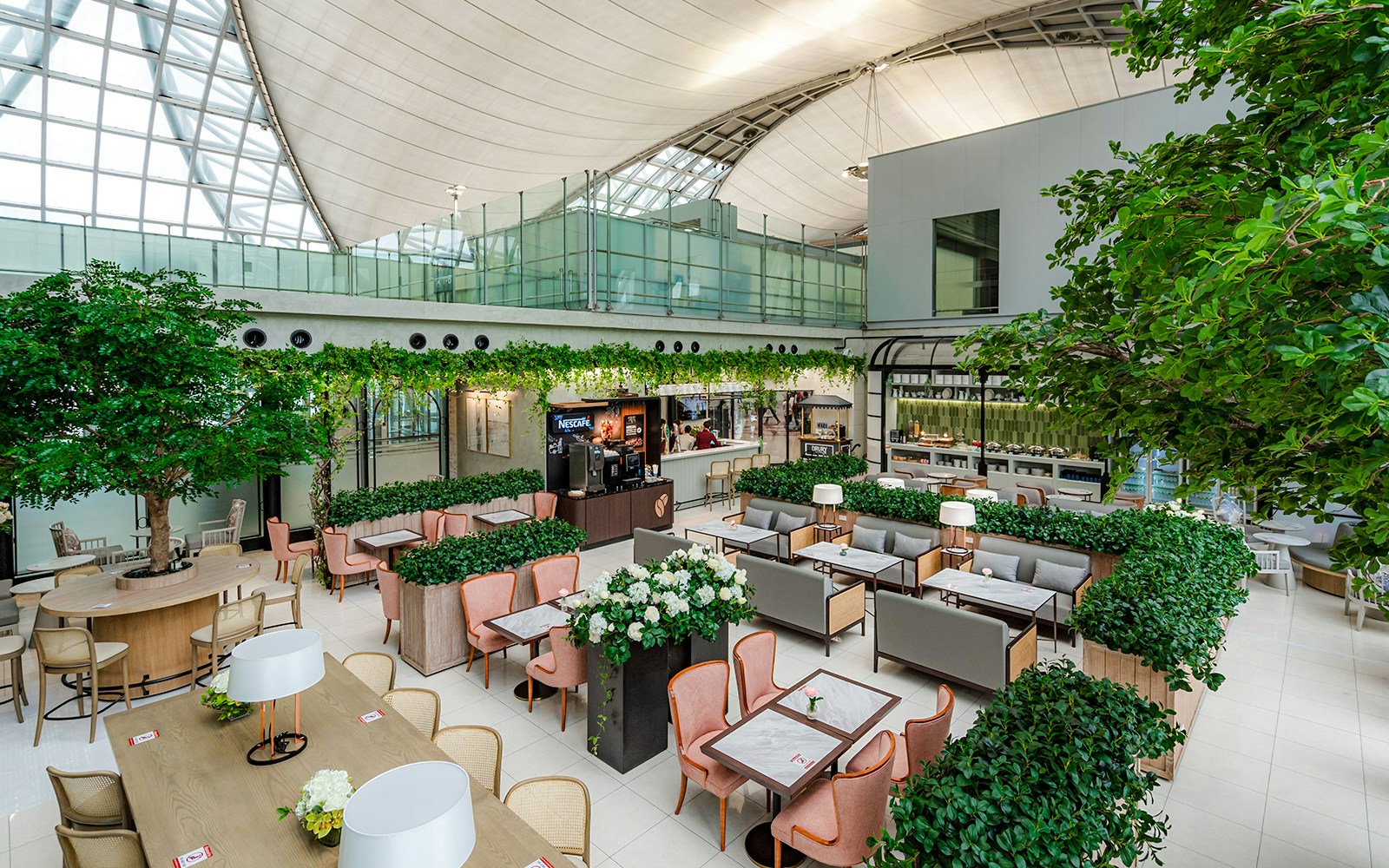 Coral Executive Lounge seating area with greenery, Bangkok airport, Thailand.
