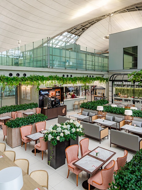 Coral Executive Lounge seating area with greenery, Bangkok airport, Thailand.