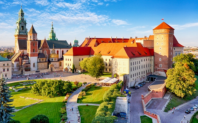 Aerial view of Wawel Castle in Krakow, showcasing its historic architecture and surrounding gardens.