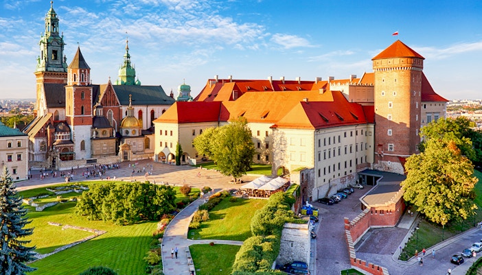 Aerial view of Wawel Castle in Krakow, showcasing its historic architecture and surrounding gardens.