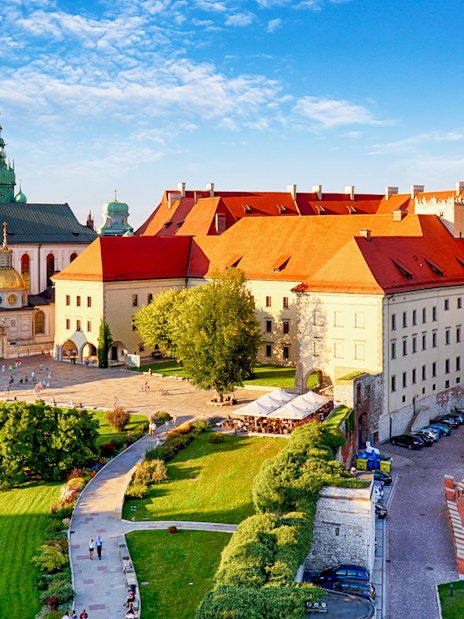 Aerial view of Wawel Castle in Krakow, showcasing its historic architecture and surrounding gardens.