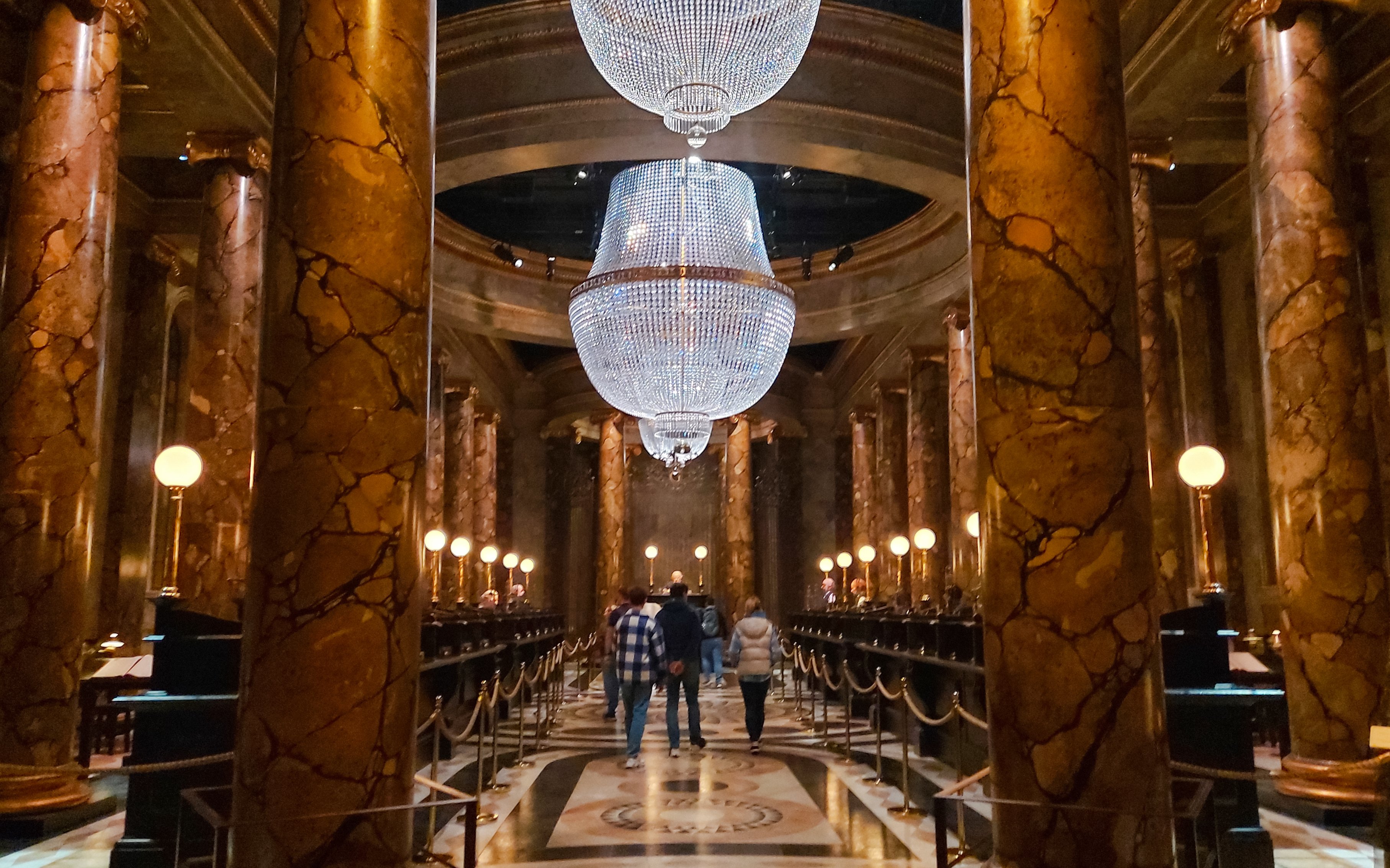 Gringotts Wizarding Bank interior with marble columns and chandeliers, Harry Potter tour.