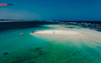 Glass-bottom boats near Robinson Island, Diani Beach, with clear turquoise waters.