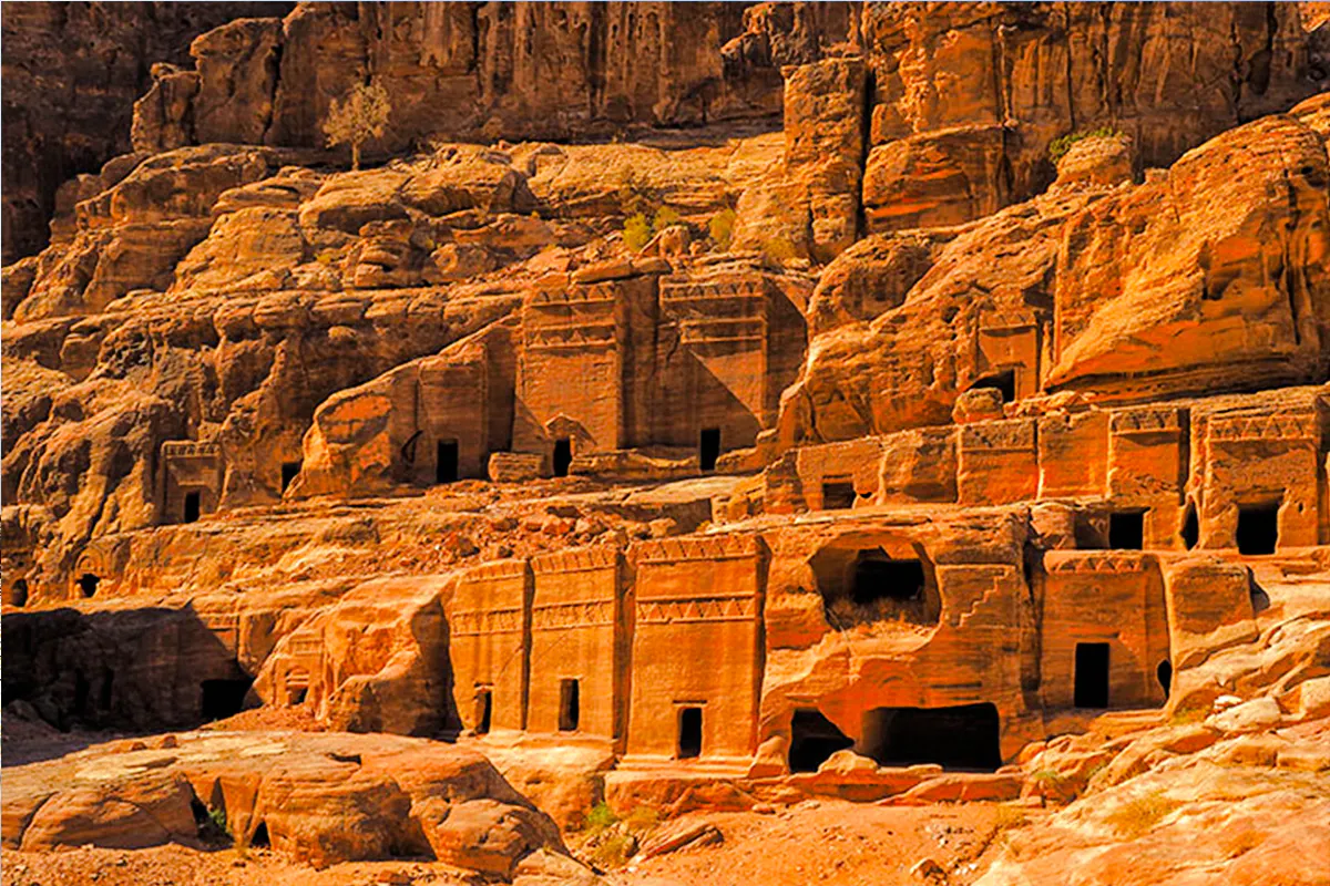 Ancient rock-cut tombs in Little Petra, Jordan, part of a guided tour from Amman.