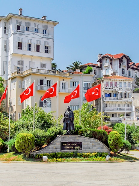Statue and Turkish flags in a square on Buyukada, Princes Islands, Istanbul.