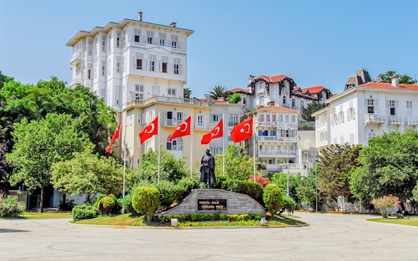Statue and Turkish flags in a square on Buyukada, Princes Islands, Istanbul.