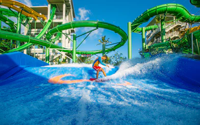 Boy surfing on Flow Rider at Waterbom Bali water park, Indonesia.