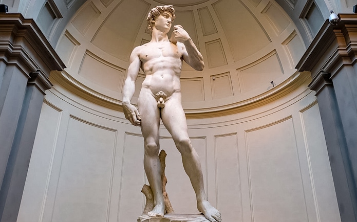 Statue of David at Accademia Gallery, Florence, viewed by tourists with reserved tickets.