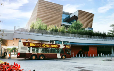 Big Bus Tours double-decker in front of Hong Kong's Xiqu Centre.