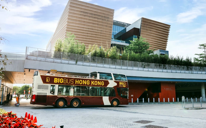 Big Bus Tours double-decker in front of Hong Kong's Xiqu Centre.
