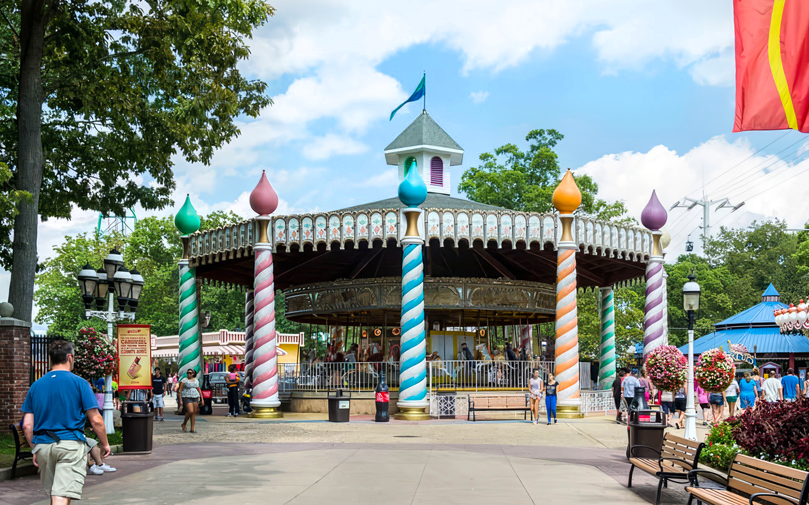 Carousel at Six Flags Great Adventure with colorful pillars and visitors nearby.