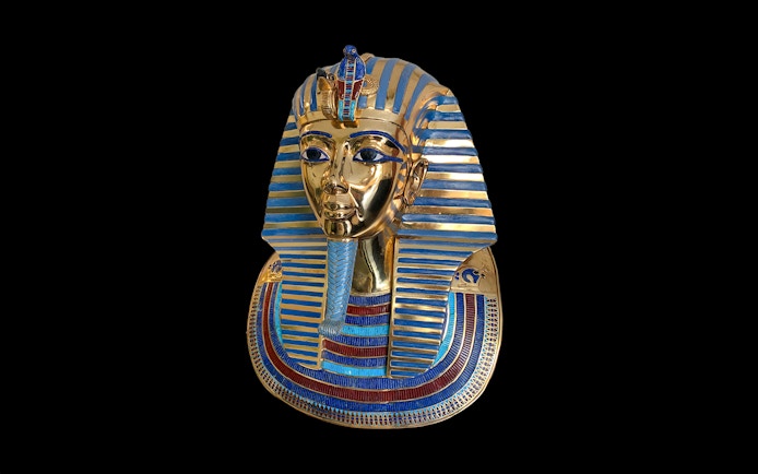 Golden mask of an Egyptian pharaoh with blue stripes, related to Tomb of the Pharaohs.