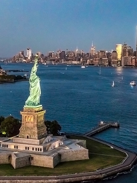 Statue of Liberty with Manhattan skyline during private NYC tour from Westchester.
