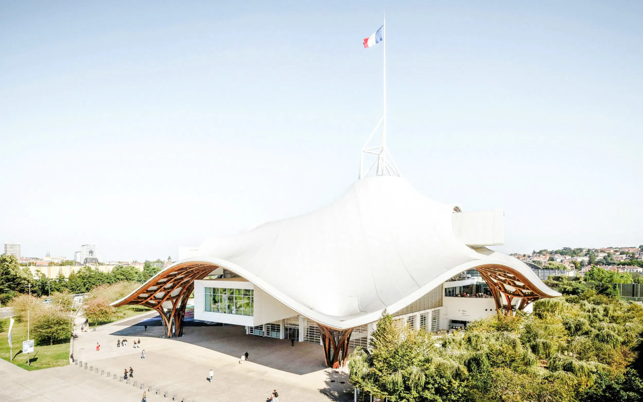 Centre Pompidou-Metz with unique roof design and French flag in Metz, France.