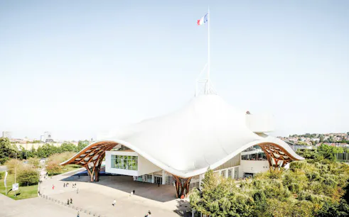 Centre Pompidou-Metz with unique roof design and French flag in Metz, France.