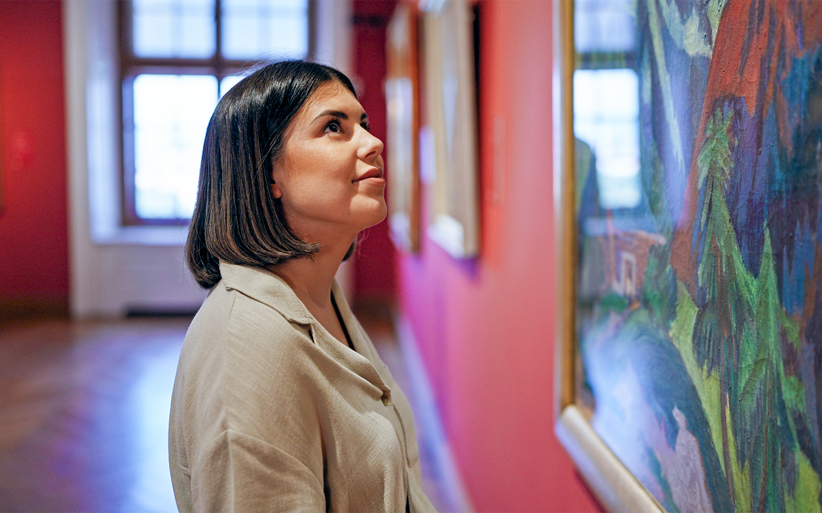 Person admiring artwork in a London museum gallery.