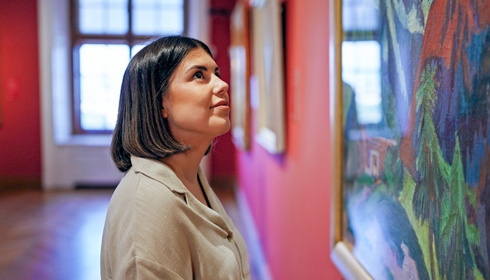 Person admiring artwork in a London museum gallery.