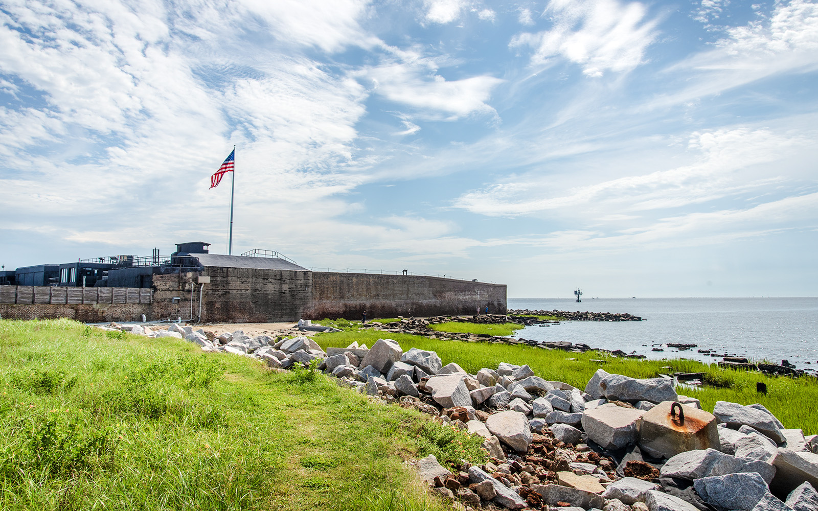 Fort Sumter National Monument with American flag and ocean view.