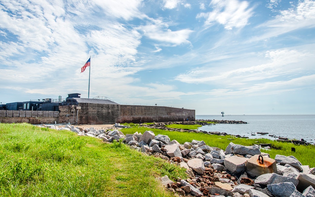 Fort Sumter National Monument with American flag and ocean view.