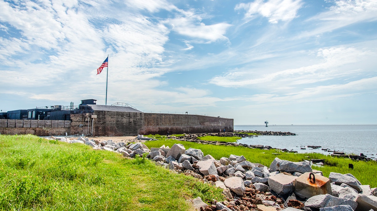 Fort Sumter National Monument with American flag and ocean view.