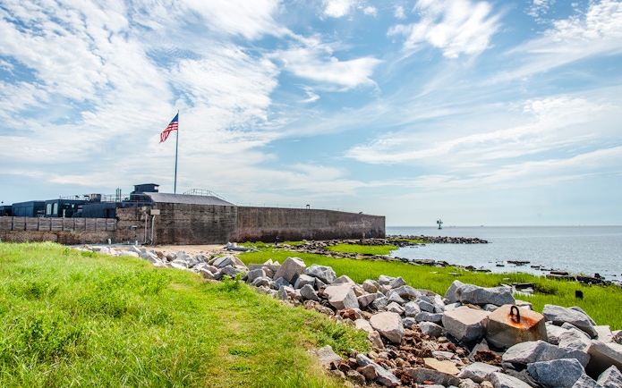 Fort Sumter National Monument with American flag and ocean view.