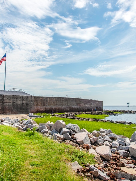Fort Sumter National Monument with American flag and ocean view.