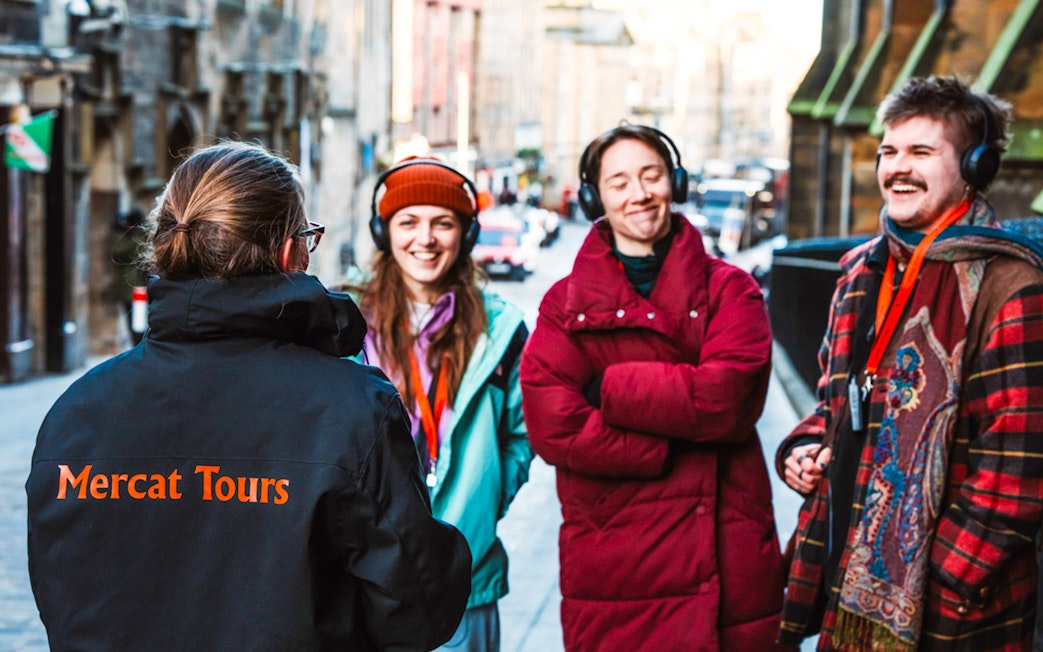Tour group on the Royal Mile with guide from Mercat Tours, Edinburgh.