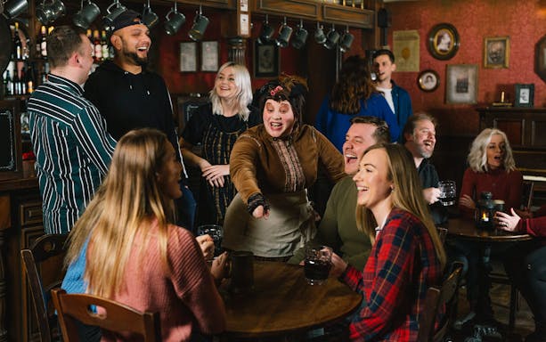Guests enjoying drinks and entertainment at the London Dungeon Tavern.