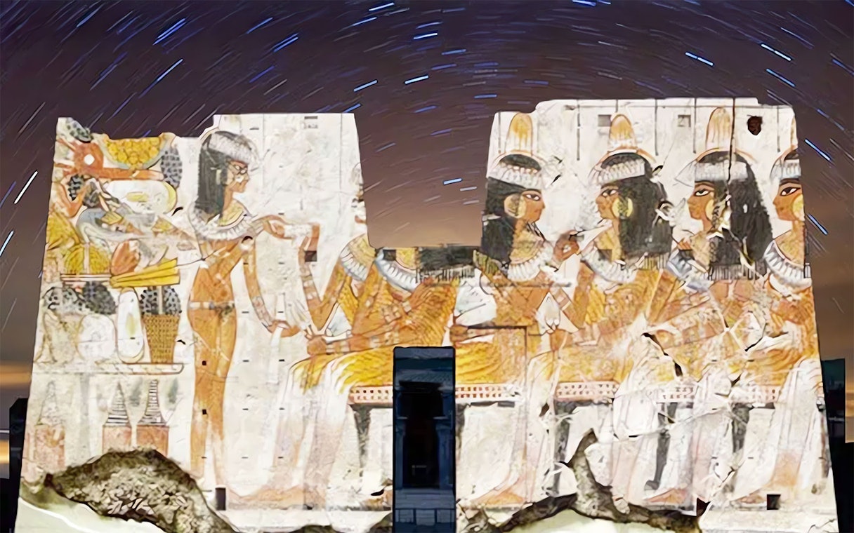 Edfu Temple illuminated with ancient Egyptian carvings during Sound and Light Show.