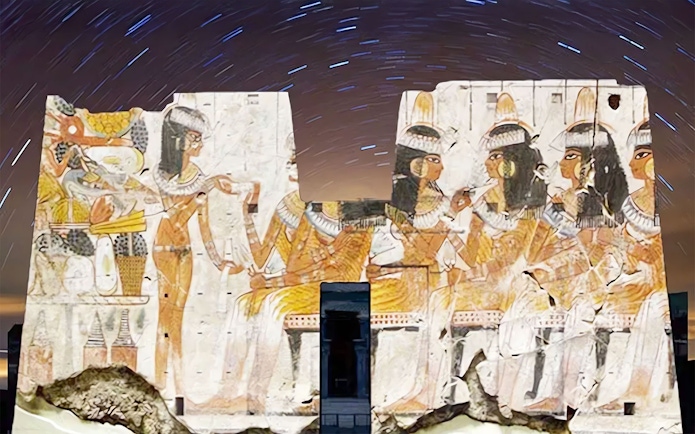 Edfu Temple illuminated with ancient Egyptian carvings during Sound and Light Show.