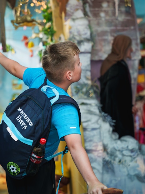 Child exploring colorful exhibits at the National Wax Museum.