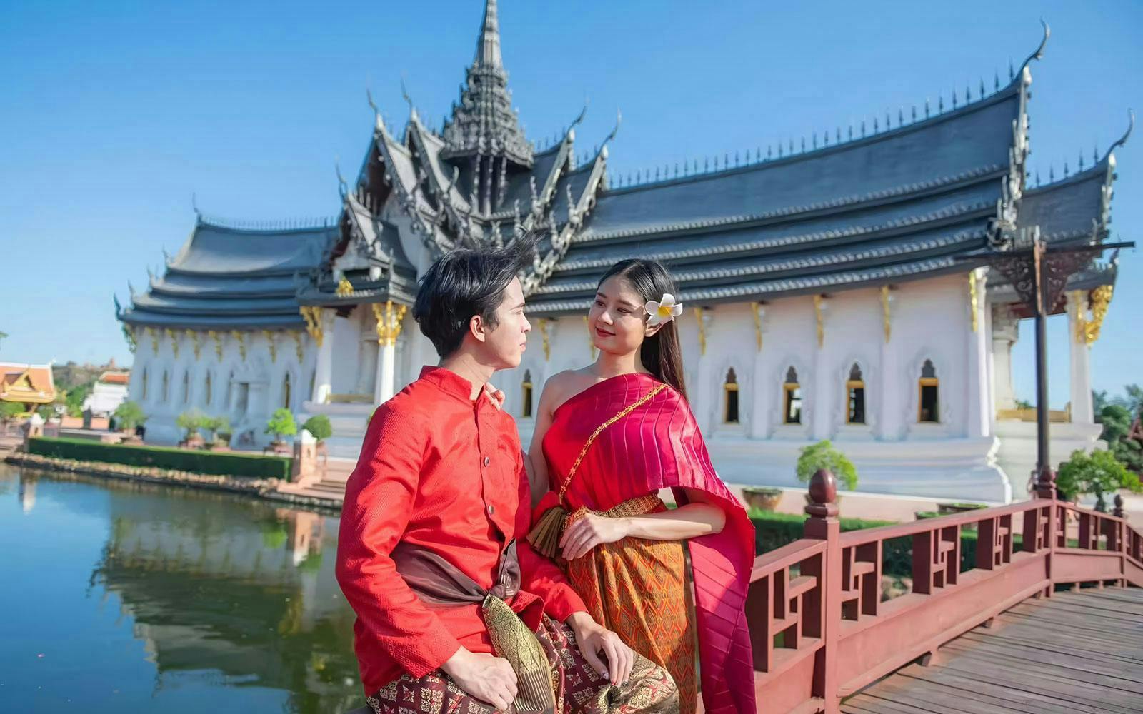 Couple in traditional attire at Ancient Siam open-air museum, Samut Prakan, Thailand.