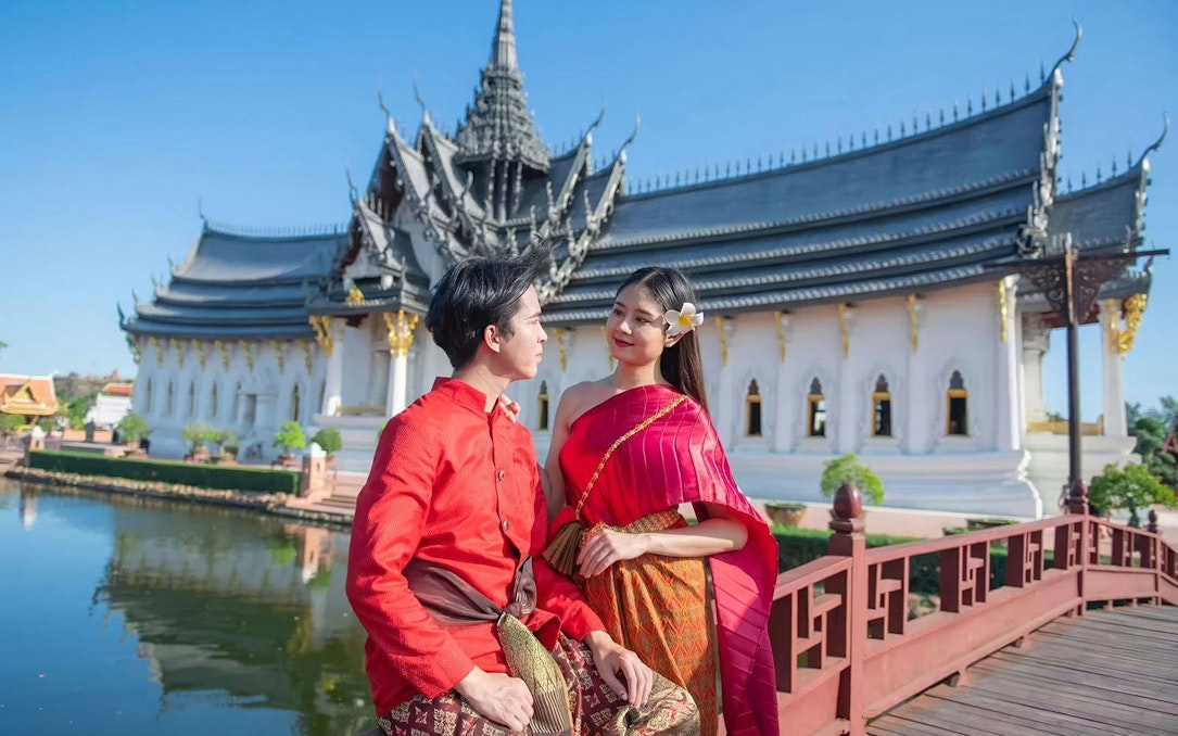 Couple in traditional attire at Ancient Siam open-air museum, Samut Prakan, Thailand.