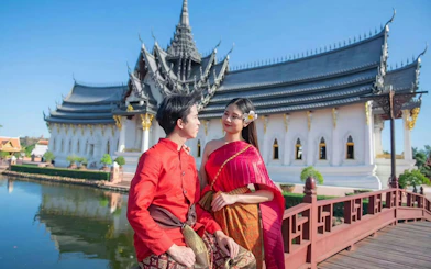 Couple in traditional attire at Ancient Siam open-air museum, Samut Prakan, Thailand.