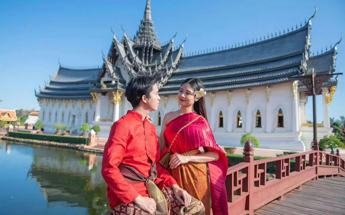 Couple in traditional attire at Ancient Siam open-air museum, Samut Prakan, Thailand.