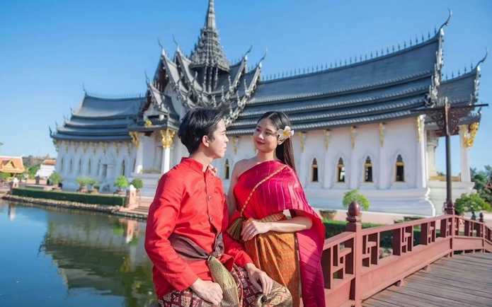 Couple in traditional attire at Ancient Siam open-air museum, Samut Prakan, Thailand.