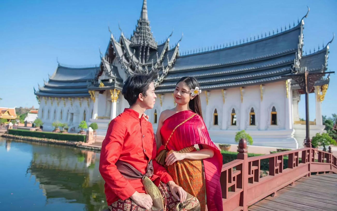 Couple in traditional attire at Ancient Siam open-air museum, Samut Prakan, Thailand.