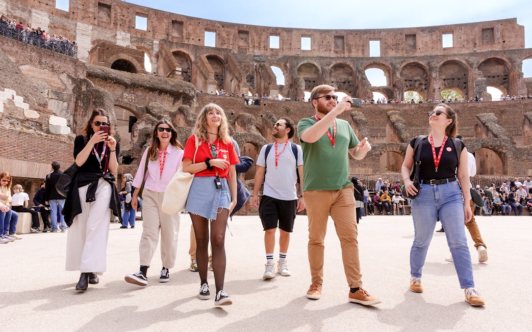 Visitors exploring the Colosseum arena during a guided tour in Rome.