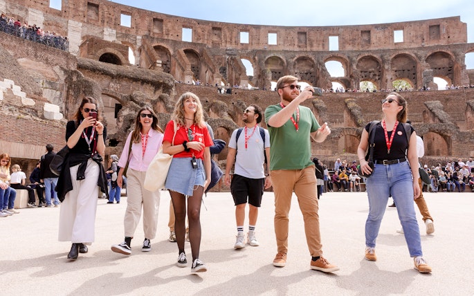Visitors exploring the Colosseum arena during a guided tour in Rome.