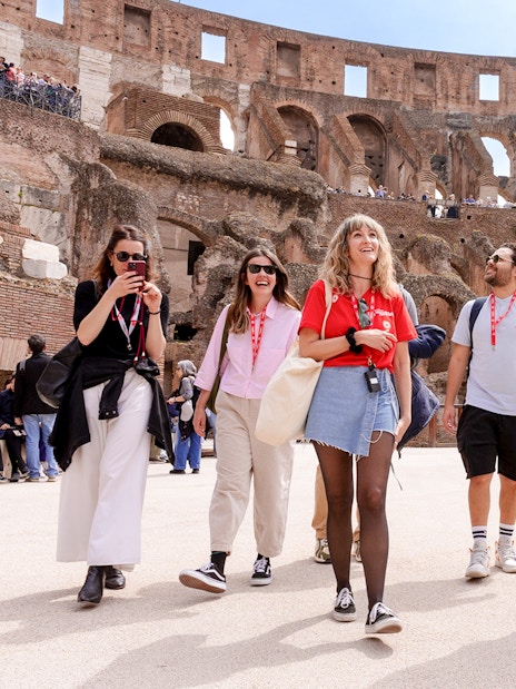 Visitors exploring the Colosseum arena during a guided tour in Rome.