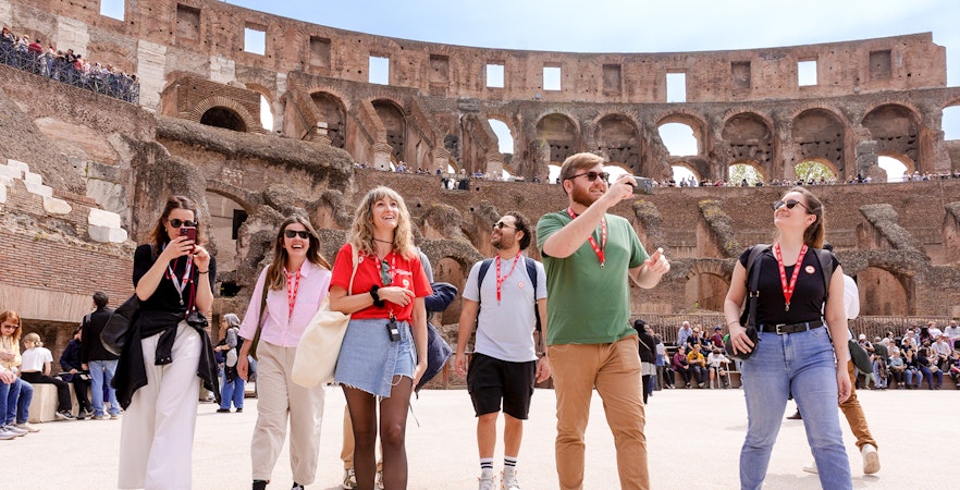 Visitors exploring the Colosseum arena during a guided tour in Rome.