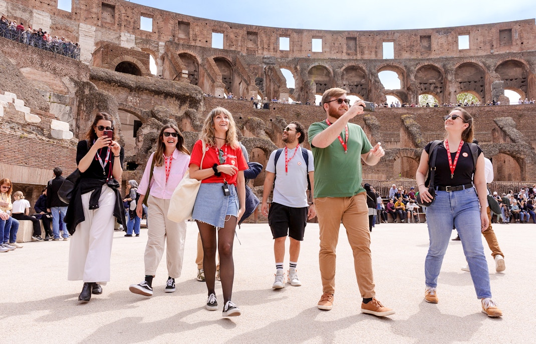 Visitors exploring the Colosseum arena during a guided tour in Rome.