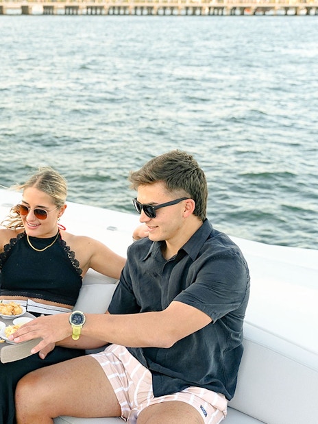 Server offering gourmet appetizers to guests on a Sunseeker superyacht.