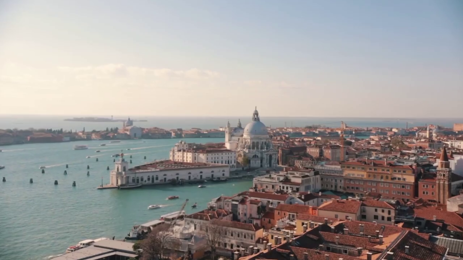 Gondola gliding through Venice's Grand Canal with historic buildings in view.